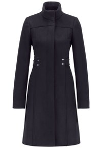 Manteau long en laine noire pour femme, avec un col montant, des manches longues, une taille ajustée et deux paires de petits boutons argentés sur les côtés.