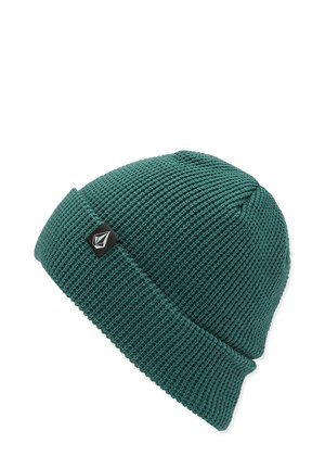 Bonnet en tricot teal avec un motif texturé et côtelé, et une bordure repliée. Présente une petite étiquette de logo noire sur le côté.