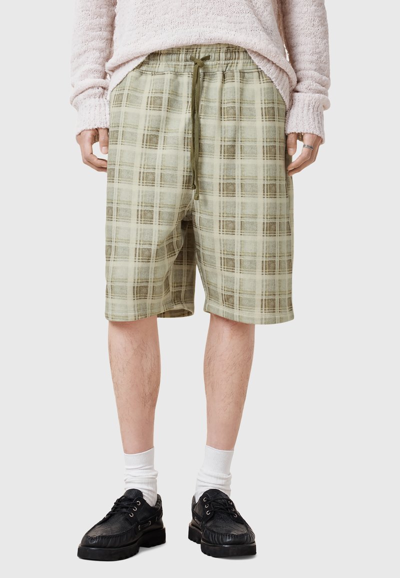 Grønne ternede shorts med elastisk talje og snor, lavet af letvægtsstof. Knælængde med en afslappet pasform.