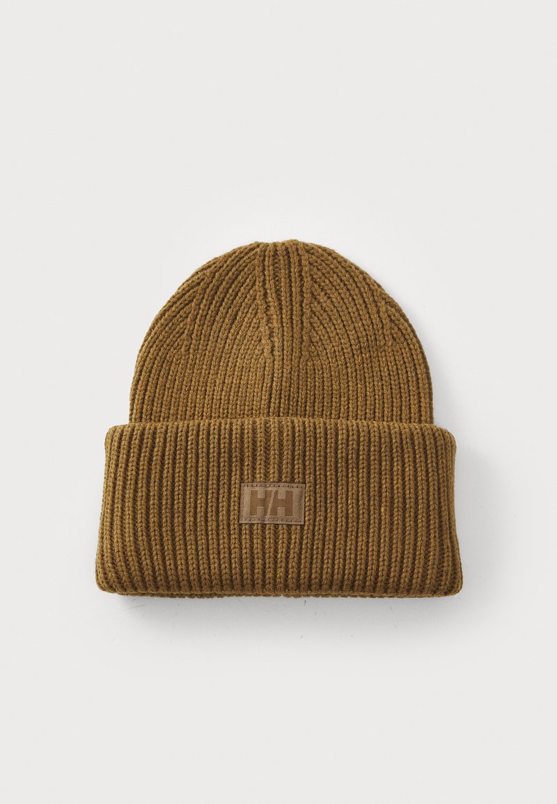 Bruine geribbelde gebreide beanie met een omgeslagen boord en een rechthoekige leren patch met het logo. Zachte textuur, gemiddelde dikte.