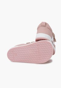 Pink synthetic shoes with a white rubber sole. Features include a textured outsole, Velcro straps, and a smooth finish. Size 21.