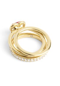 Gold-tone ring set featuring three interlocking bands, two smooth and one adorned with clear crystals along its edge.