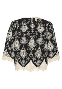 Svart blus med intrikata vita blommor och paisleymönster broderi. Har en vågig spetskant och en liten öppning på ryggen. Löst sittande design.