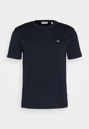 Marineblå bomulds T-shirt med rund hals, korte ærmer og et lille logo broderet på venstre bryst. Blød tekstur, normal pasform.