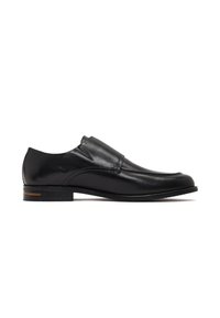 Zapato de vestir de cuero negro con textura suave, punta redondeada y diseño sin cordones que incluye paneles laterales elásticos y un pequeño tacón apilado.