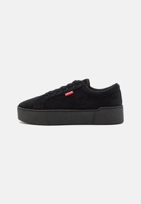 Black suede sneakers with a thick black sole, featuring a red Levi's logo on the side and round laces. Smooth texture and simple design.