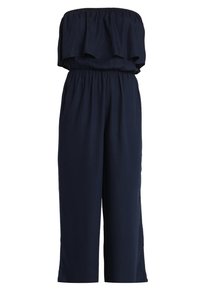 Tmavě modrý overal bez ramínek vyrobený z měkké tkaniny, s volánkovým vrškem, elastickým pasem a širokými nohavicemi. Není vidět žádné kapsy.