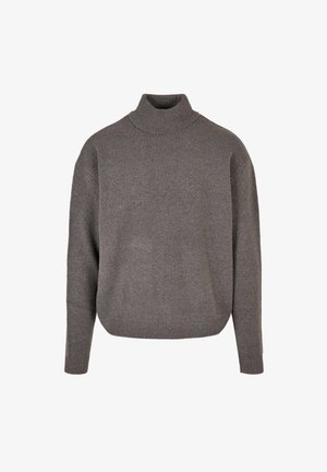 Pull en col roulé gris en tissu tricoté doux et texturé. Coupe ample, avec des manches longues et des poignets et un ourlet côtelés.