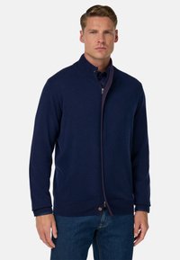 Marineblauer Reißverschluss-Pullover mit hohem Kragen, strukturiertem Stoff und gerippten Bündchen und Saum. Verfügt über einen kontrastierenden Reißverschluss und Knopfdetail.