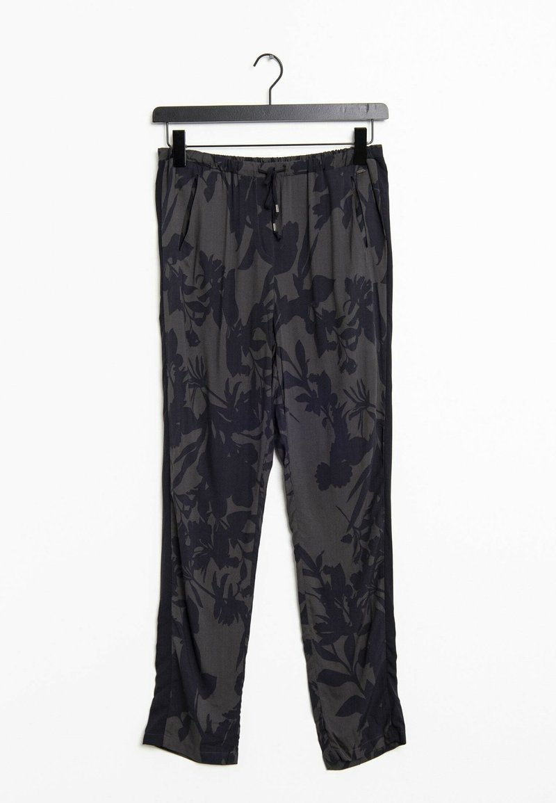 Pantalon gris foncé avec motifs floraux noirs, taille élastique et poches latérales suspendu à un cintre noir sur fond blanc.