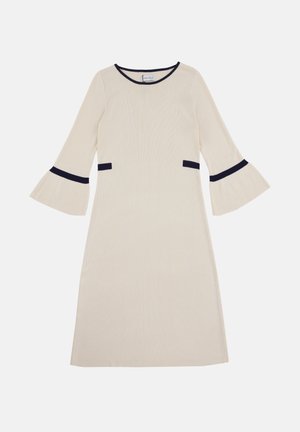 Robe couleur crème avec des manches cloche et des accents bleu marine au niveau du col et des poches. Texture côtelée sur l'ensemble du tissu.