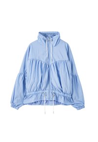 Veste bleu clair à fermeture éclair avec col montant, cordons blancs au niveau du cou et de la taille, coupe ample et poignets élastiques aux manches longues.