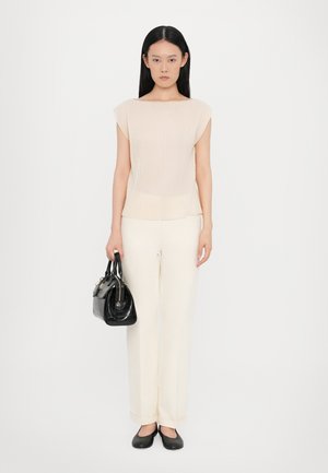 Cream ribbed short-sleeve top, paired with cream wide-leg trousers. Black structured handbag and black flats complete the look.