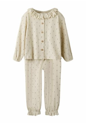 Ensemble à deux pièces de couleur crème, avec un col volant, une fermeture à boutons et de petits motifs floraux sur le haut et le bas, ainsi que des poignets élastiques.