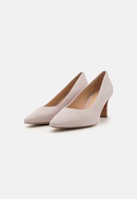 Pointed-toe heels in soft beige suede with a textured brown wooden heel. Smooth inner lining and minimalistic design.