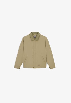 Beige jacka i slitstark tyg, med spetsig krage, två framfickor och knäppning med knappar. Minimalistisk design och rak skärning.