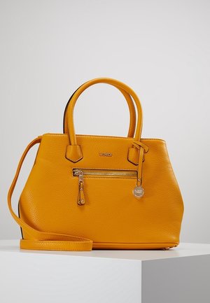 Yellow textured leather handbag with two handles, front zipper pocket, branded metal charm, and detachable shoulder strap on white pedestal.