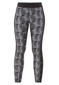 Leggings atletici a righe bianche e nere con una cintura larga e pannelli laterali a contrasto. Il design presenta forme geometriche e texture.