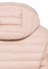 Veste rembourrée rose clair avec un design matelassé horizontal et une capuche arrondie. Fabriquée en matériau synthétique avec une finition lisse.