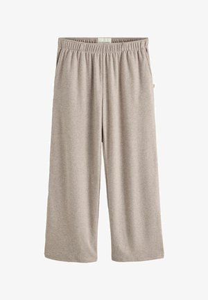 Beige, weit geschnittene Lounge-Hose mit elastischem Bund und Seitentaschen, aus weichem Stoff, geeignet für lässige Kleidung.