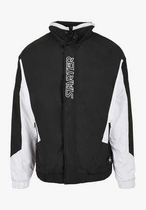 Veste zippée noire et blanche avec col montant, poignets élastiques, poches latérales et logo "STARTER" en lettres blanches sur la zone de la fermeture éclair frontale.