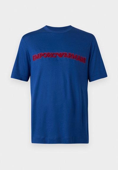 Μπλε κοντομάνικο t-shirt με στρογγυλή λαιμόκοψη και κέντημα "EMPORIO ARMANI" σε κόκκινο χρώμα στο στήθος.