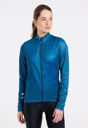 Blue long-sleeve jacket with zip closure, featuring a geometric pattern in darker blue, and logo detail on the front. Smooth texture.