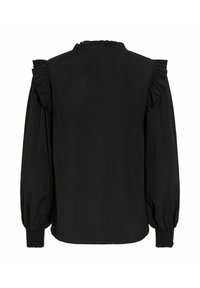 Blouse noire avec des accents volants sur les épaules, un col haut avec volants et des poignets froncés pour une coupe décontractée.
