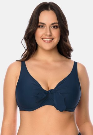 Navyblauer Bikini-Oberteil mit glatter Textur, breiten Trägern und einem zentralen Schleifendetail. Verfügt über einen tiefen Ausschnitt und sanfte Raffung.