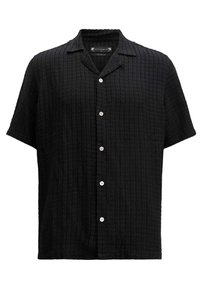 Chemise noire texturée en forme de gaufre, à manches courtes, à boutons avec col ouvert et boutons blancs sur le devant.