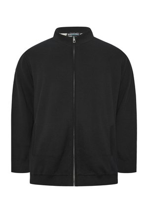 Chaqueta negra con cremallera completa, cuello alto, mangas largas y dos bolsillos laterales, con la etiqueta "BADRHINO" en el interior del cuello.