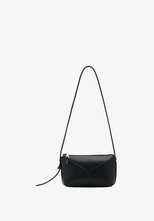 Black leather shoulder bag with long strap, zip closure, and subtle V-shaped stitching on front panel, shown on white background.