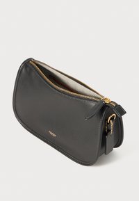 Black leather clutch bag with curved shape, gold zipper, and logo. Features a beige interior lining and a small detachable accessory tag.