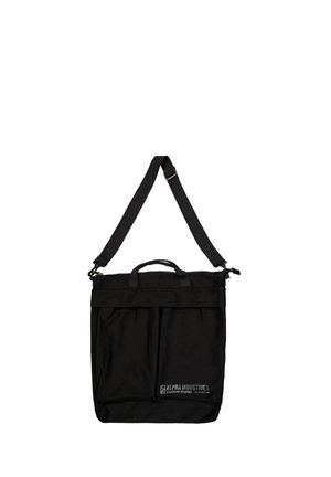Black rectangular tote bag with adjustable shoulder strap, handles, front zip pocket, and small Alpha Industries logo on lower right.