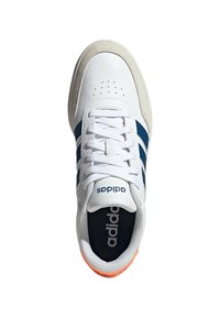 White leather sneaker with blue three stripes, gray suede accents, and an orange heel. Features white laces and a black interior.