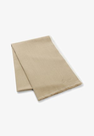Sandfarvet tørklæde lavet af blød stof, med frynser i kanten og en subtil signaturdekoration i det ene hjørne. Glat tekstur.