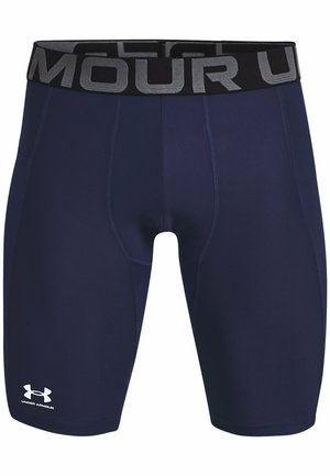 Bermudas deportivas azul marino hechas de material elástico, con una cinturilla negra que presenta letras grises y un logo blanco en la pierna izquierda.