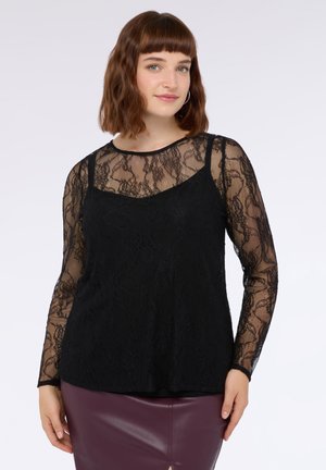 Top de encaje negro de manga larga con una capa transparente, escote redondo y una capa inferior ajustada. El diseño presenta patrones florales.