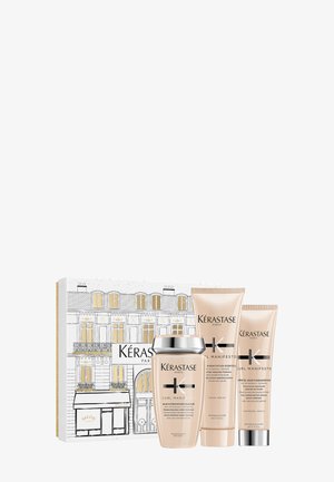 Kérastase Curl Manifesto Haarschutzset in einer weißen und goldenen illustrierten Box, bestehend aus einem Shampoo mit silbernem Deckel und zwei beigen Tuben.