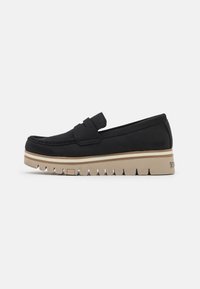Black slip-on loafers with a soft upper, a rounded toe, and a cushioned beige platform sole featuring textured grooves. Accent band across the top.