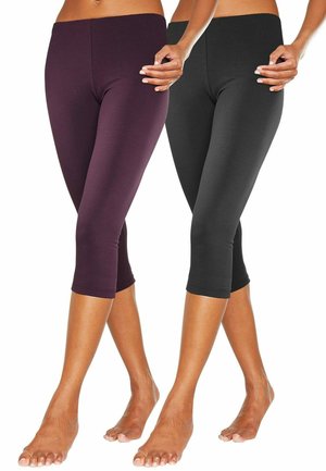 Capri-legging in zwart en bordeauxrood. Gemaakt van rekbare stof, met een aansluitend ontwerp en een gladde afwerking, gecropd tot halverwege de kuit.