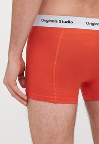 Oranžové bavlněné boxerky s bílým elastickým pasem s logem "Originals Studio". Hladká textura a přiléhavý design se bočním švem.
