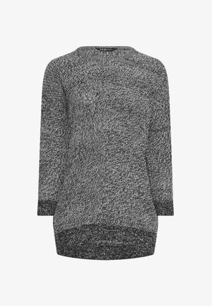 Maglione lavorato a maglia in bianco e nero con maniche lunghe, scollo rotondo e un motivo testurizzato. Orlo posteriore più lungo rispetto a quello anteriore.