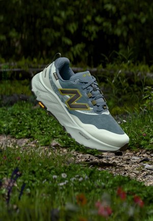 Men's running shoe with a gray and green design, mesh upper, thick white midsole, and textured sole. Features a prominent "N" logo.