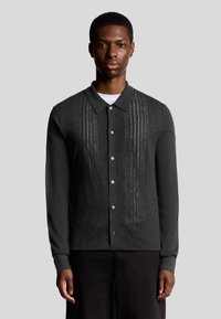 Donkergrijze cardigan met kraag en knopen, met verticale gestreepte breipatronen en textuurstof. Met lange mouwen.