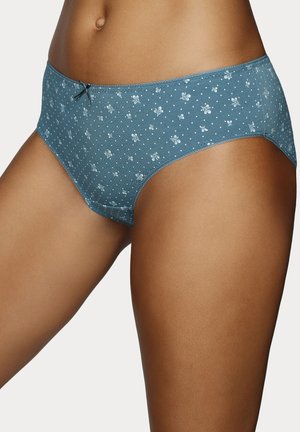 Woman wearing blue cotton briefs with small white floral and polka dot pattern and a small bow at the waistband center.