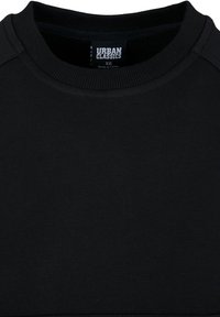 Sweat-shirt noir à col rond avec col côtelé et étiquette de marque "Urban Classics" visible en taille XS.