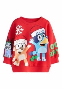 Rote Sweatshirt mit cartoonhaften Hunden in Hüten, einer Schneeflocke und Stechpalme. Der Stoff ist weich, mit lockerer Passform und weitem Ausschnitt.