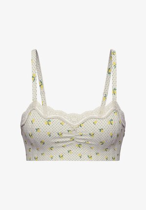 Reggiseno realizzato in morbido tessuto crema con pois neri e disegni di limoni gialli. Presenta un bordo in pizzo e spalline regolabili.