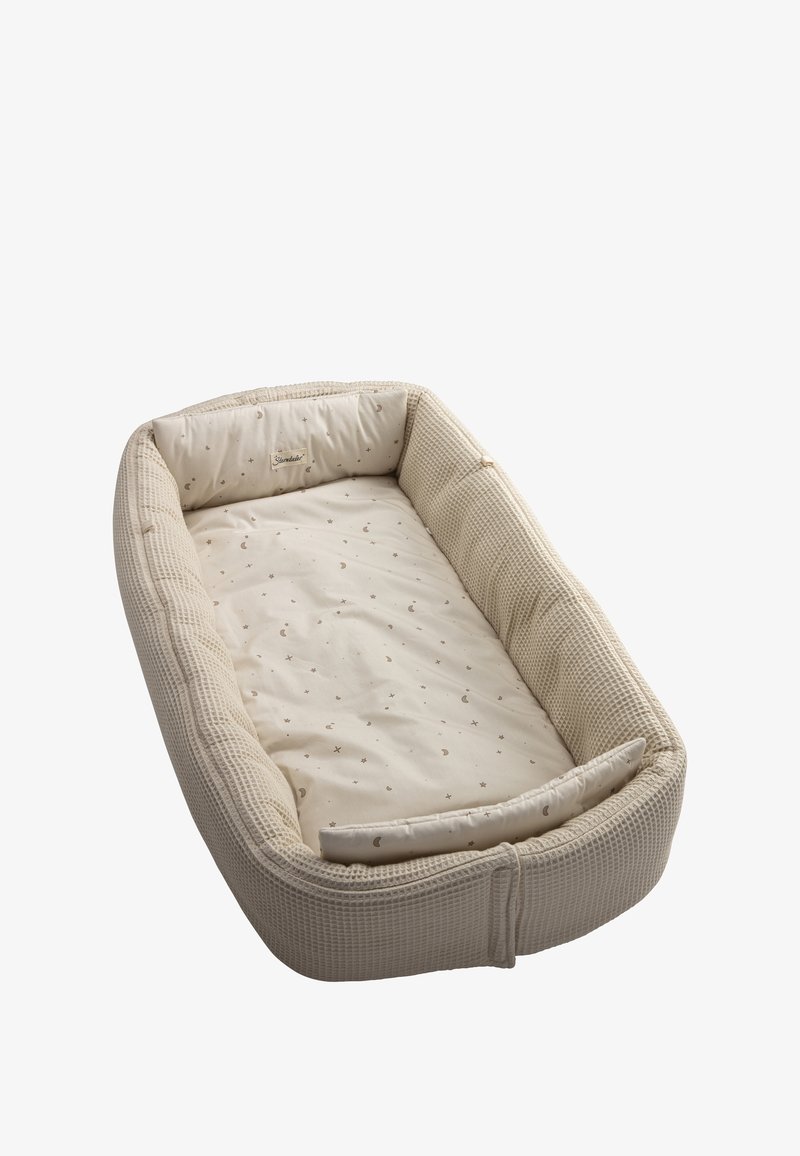 Baby nest with a woven textured exterior in beige, featuring a soft, patterned interior with moon and star designs. Cushioned edges for comfort.